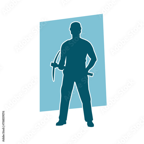 Silhouette of a man in worker costume carrying pick axe tool in action pose.