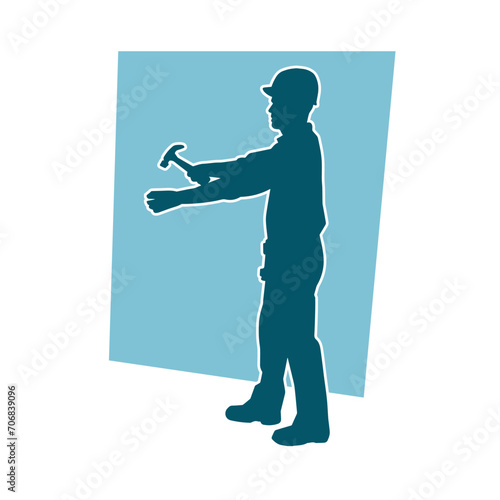 Silhouette of a worker carrying hammer tool. Silhouette of a worker in action pose using hammer tool.