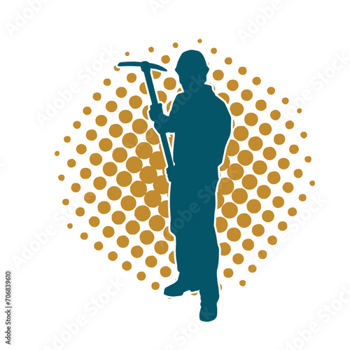 Silhouette of a man in worker costume carrying pick axe tool in action pose.