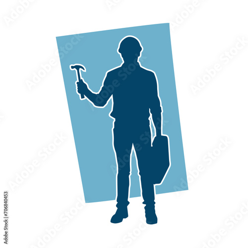 Silhouette of a worker carrying hammer tool. Silhouette of a worker in action pose using hammer tool.