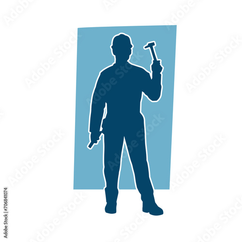 Silhouette of a worker carrying hammer tool. Silhouette of a worker in action pose using hammer tool.