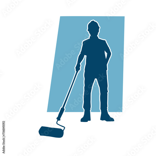 Silhouette of a male worker doing painting work. Silhouette of an interior painter worker.