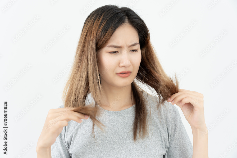 Asian woman very sad and upset looking at damaged hair, hair loss, hair thinning problem, vitamin deficiency, baldness, postpartum, biotin, zinc, menstrual or endocrine disorders, hormonal imbalance Asian woman very sad and upset looking at damaged hair, hair loss, hair thinning problem, vitamin deficiency, baldness, postpartum, biotin, zinc, menstrual or endocrine disorders, hormonal imbalance