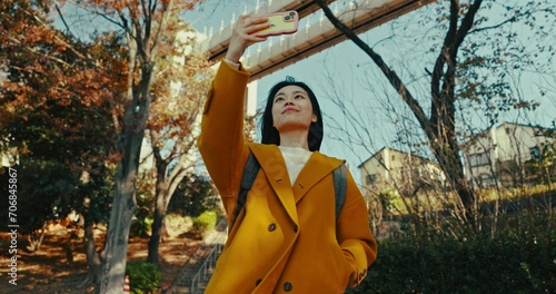 Photography Japanese woman, selfie and smartphone in city with happiness, holiday adventure and wellness by technology