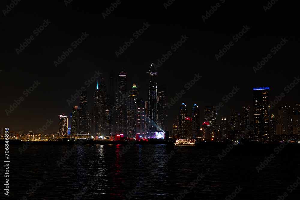 Beautiful night view of Dubai skyscrapers from the sea. Night panorama of Dubai Marina
