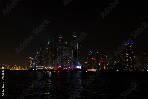 Beautiful night view of Dubai skyscrapers from the sea. Night panorama of Dubai Marina