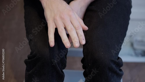 Close-up of Anxious Caucasian Man's Nervous Gestures and Shaking Hands photo