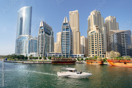 View Dubai Marina towards with building construction and boats during a sunny day. boat trip on a yacht.