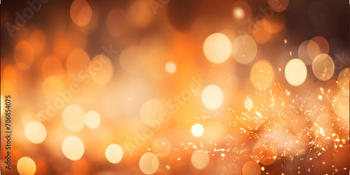 Golden particles and sprinkles for a holiday celebration like. shiny golden lights. Gold dust light bokeh. Wallpaper background for ads or gifts wrap and web design.