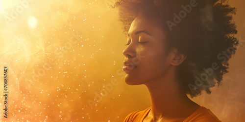 African American woman with healing energy and light around her feeling good breathing calm peace. Happy black female smiling in happiness taking deep breath for zen, health or spiritual wellness photo
