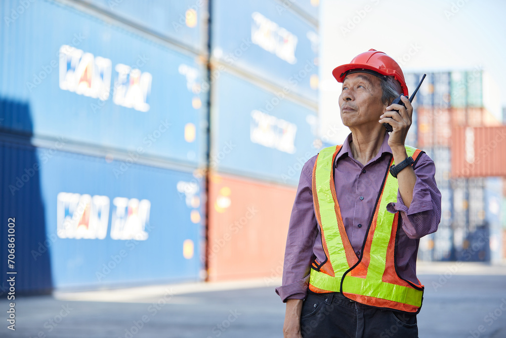senior factory worker or engineer talking on walkie talkie in containers warehouse storage senior factory worker or engineer talking on walkie talkie in containers warehouse storage