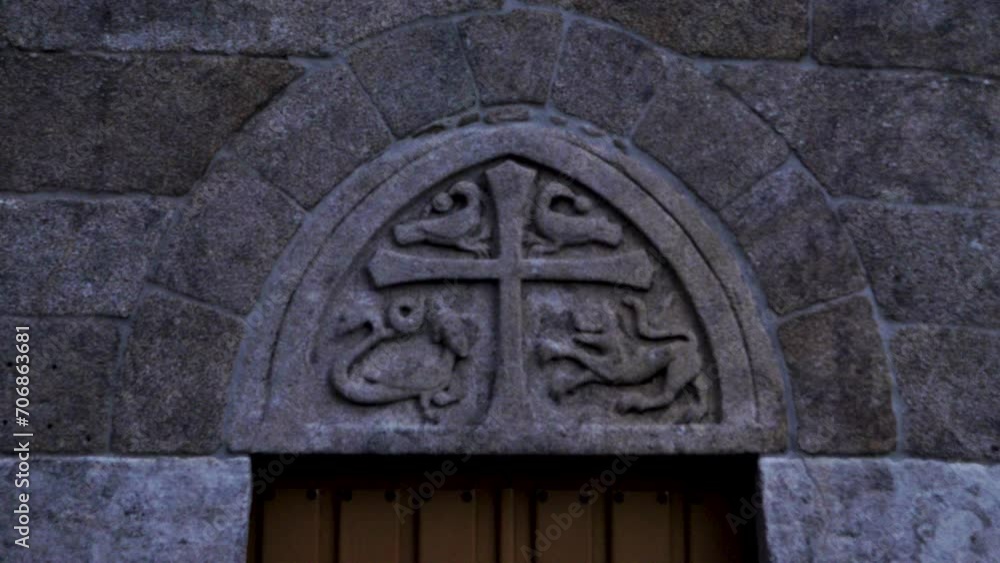 Carved stone detail of cross and snake lion and fish animals in old church Carved stone detail of cross and snake lion and fish animals in old church