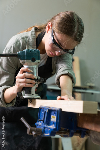 Wallpaper Mural Female Carpenter Wearing Protective Safety Glasses and Using Electric Work on a Wood. Artist or Furniture Designer Working on a Product Idea in a Workshop. Torontodigital.ca