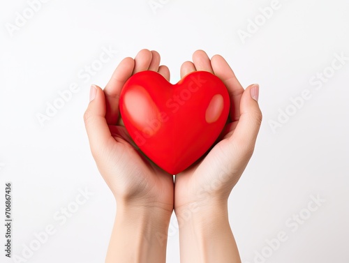 A red heart that is carefully held with both hands  Love  Valentine s day