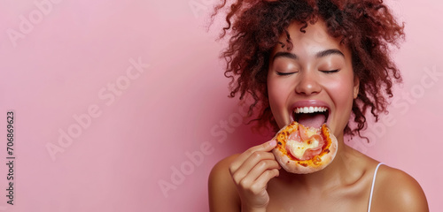 Happy teenager enjoys eating delicious slice of pizza   snack with fastfood in lunch