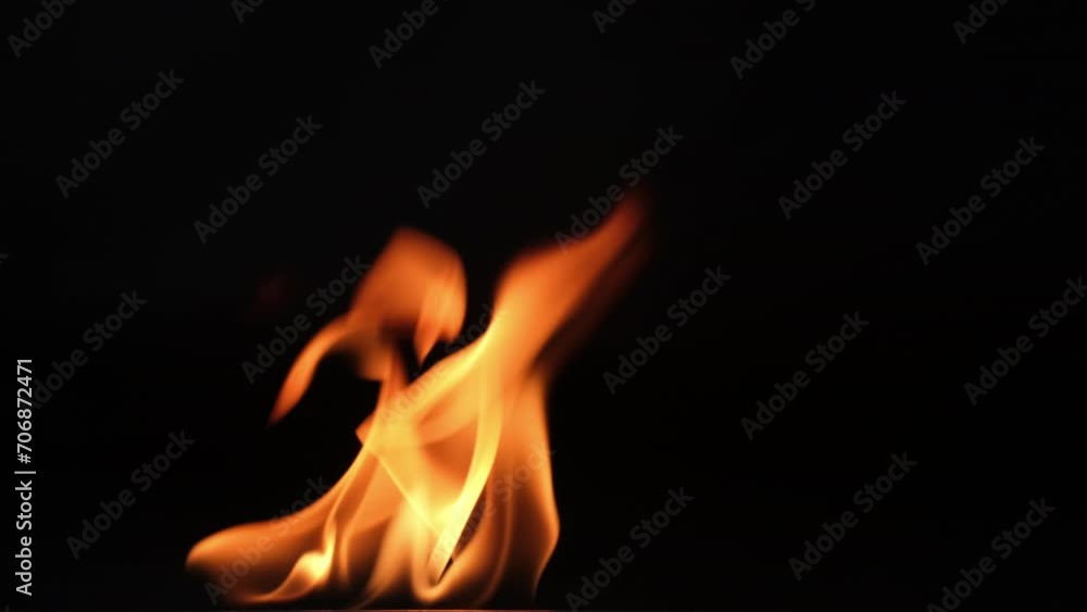 Hot flames on a black background. Beautiful flame of fire in the dark. Abstract of burning flames and smoke. Hot flames on a black background. Beautiful flame of fire in the dark. Abstract of burning flames and smoke.