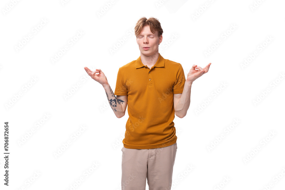 surprised red-haired guy dressed in an orange t-shirt on a white background surprised red-haired guy dressed in an orange t-shirt on a white background