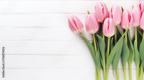 Pink Tulips on White Wooden Background, A fresh bouquet of pink tulips lies against a white wooden backdrop, creating a serene and pure springtime atmosphere.