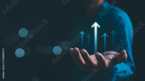 Hand holding growth business strategy arrow concept on success target improvement with increase development graph profit or economy investment income target and goal increase achievement.