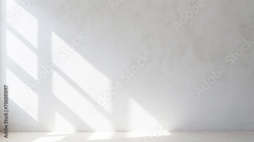 Minimalistic abstract light grey wall background for product presentation with sunlight shadow photo
