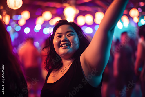 portrait of confident overweight happy dancing Asian woman in crowded nightclub embodying body positivity, selective focus shot with neon lights photo