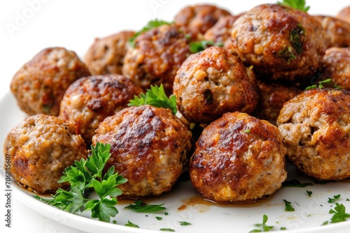 A plate of meatballs topped with fresh parsley. Perfect for a delicious and satisfying meal.