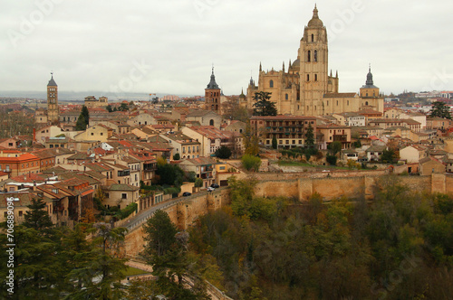 Panoramic view of the historic part of the city surrounded by medieval walls with numerous churches and Cathedral in the center of the photo in the city of Segovia, near Madrid, Spain