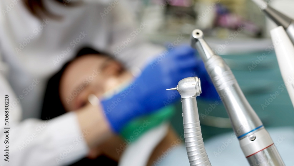 Young female dentist during work process, close-up of young woman's dental treatment. Concept of healthy teeth and modern treatment in a dental clinic.