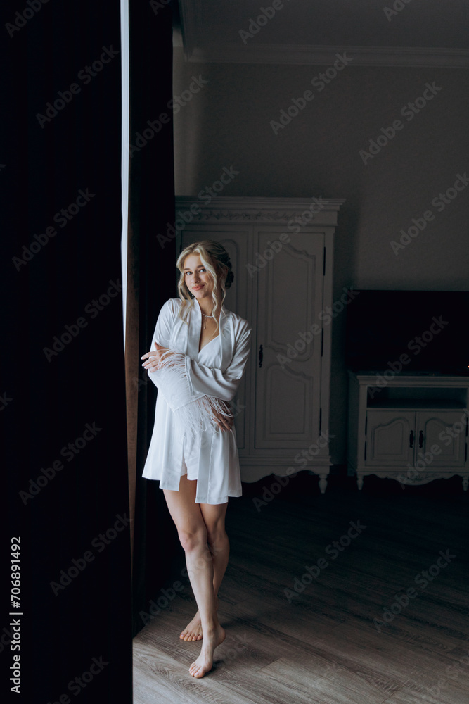 Morning of the bride, where she gets ready for a wedding in a beautiful luxury hotel in a robe with stylish hair and makeup, and then puts on a white wedding dress. Morning of the bride, where she gets ready for a wedding in a beautiful luxury hotel in a robe with stylish hair and makeup, and then puts on a white wedding dress.