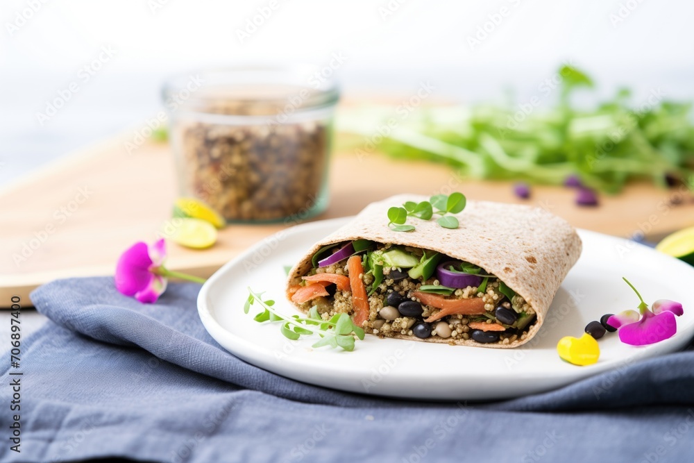 flaxseed wrap containing quinoa and black beans on burlap