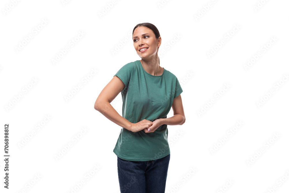 young black-haired woman in a green basic t-shirt posing on a white background young black-haired woman in a green basic t-shirt posing on a white background