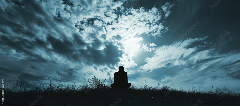 Silhouette of a lonely man looking at the sky with copy space - obrazy, fototapety, plakaty 