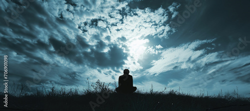 Silhouette of a lonely man looking at the sky with copy space