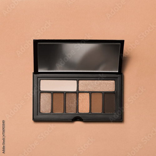 Various makeup products on dark background with copyspace (ID: 706903849)