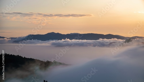 Photograph of white fog with mountains on the side