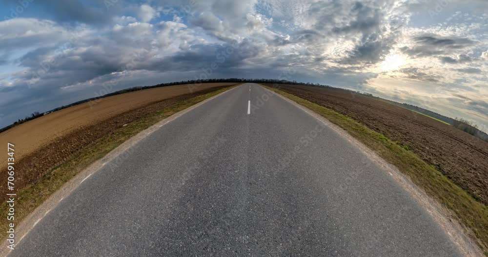 tiny planet transformation with curvature of space among fields on asphalt road in sunny day with sky and fluffy clouds tiny planet transformation with curvature of space among fields on asphalt road in sunny day with sky and fluffy clouds