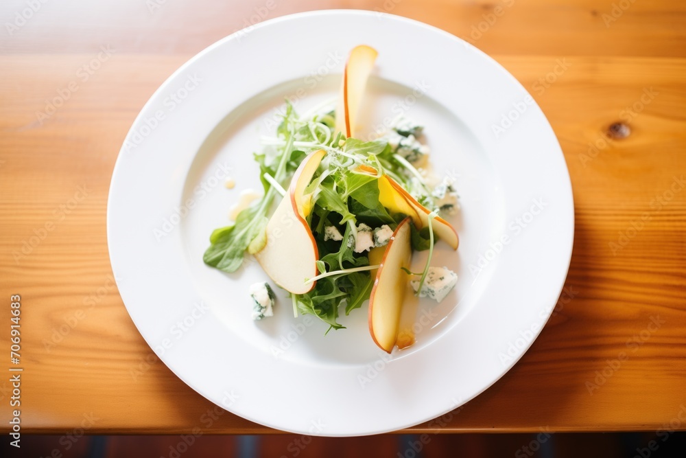 mixed greens, pear, and blue cheese on plate mixed greens, pear, and blue cheese on plate
