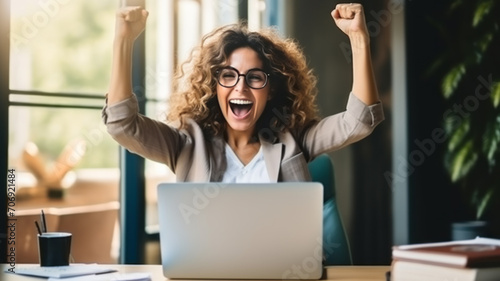 Joyful business woman freelancer entrepreneur smiling and rejoices in victory