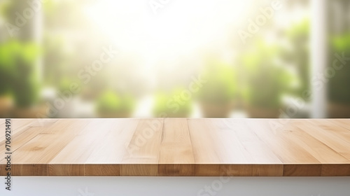 Empty beautiful wood table top counter and blur bokeh modern kitchen interior background in clean and bright. Banner with copy space
