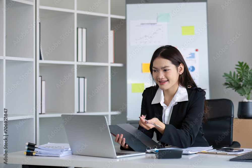 Business documents, business auditor Asian woman is reviewing legal documents, preparing documents or reports for analysis tax accountant documents agreement contract information in office at work Business documents, business auditor Asian woman is reviewing legal documents, preparing documents or reports for analysis tax accountant documents agreement contract information in office at work