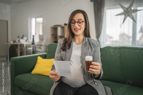 Expectant woman read leaflet take tablets medication or supplement