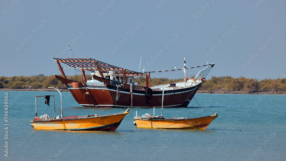 Traditional Dhow old wooden boat in the harbor of Iranian Qeshm Island. Tradition Lenj Fishing Boat in Qeshm Island in Southern Iran. Old wooden stealth smuggler's ship