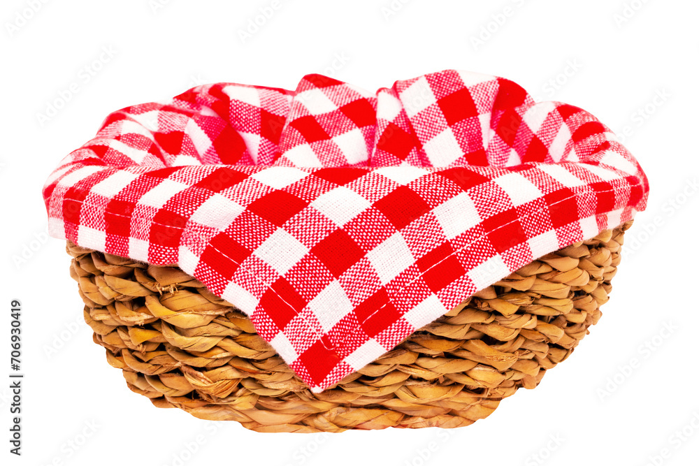 Empty picnic basket. Close-up of a empty straw basket therein a red checkered napkin isolated on a white background. For your food and product display montage. Macro.
