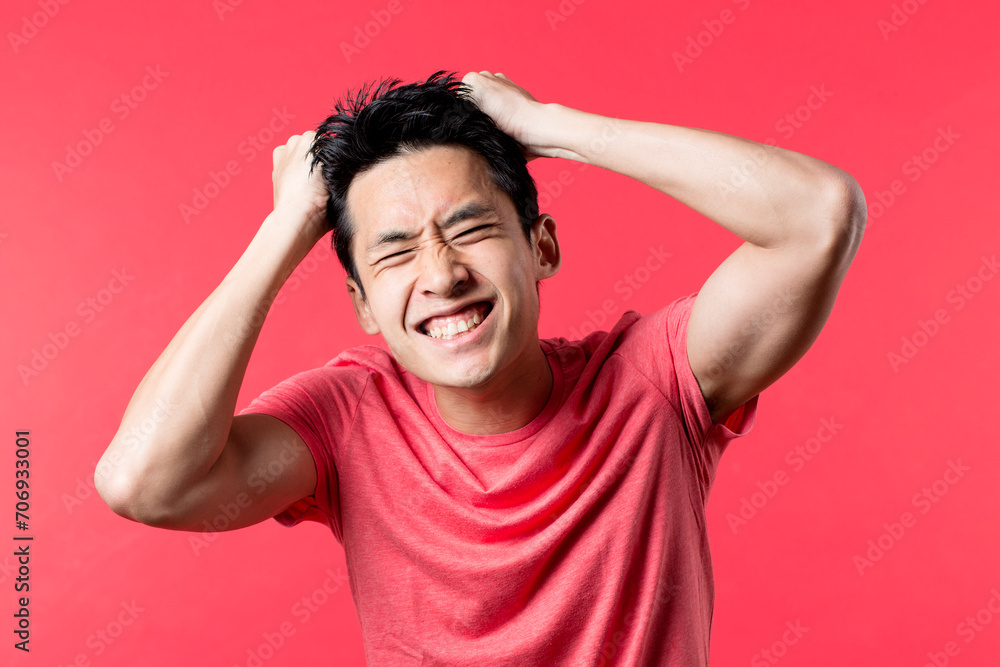 Anxious Chinese man holding his head