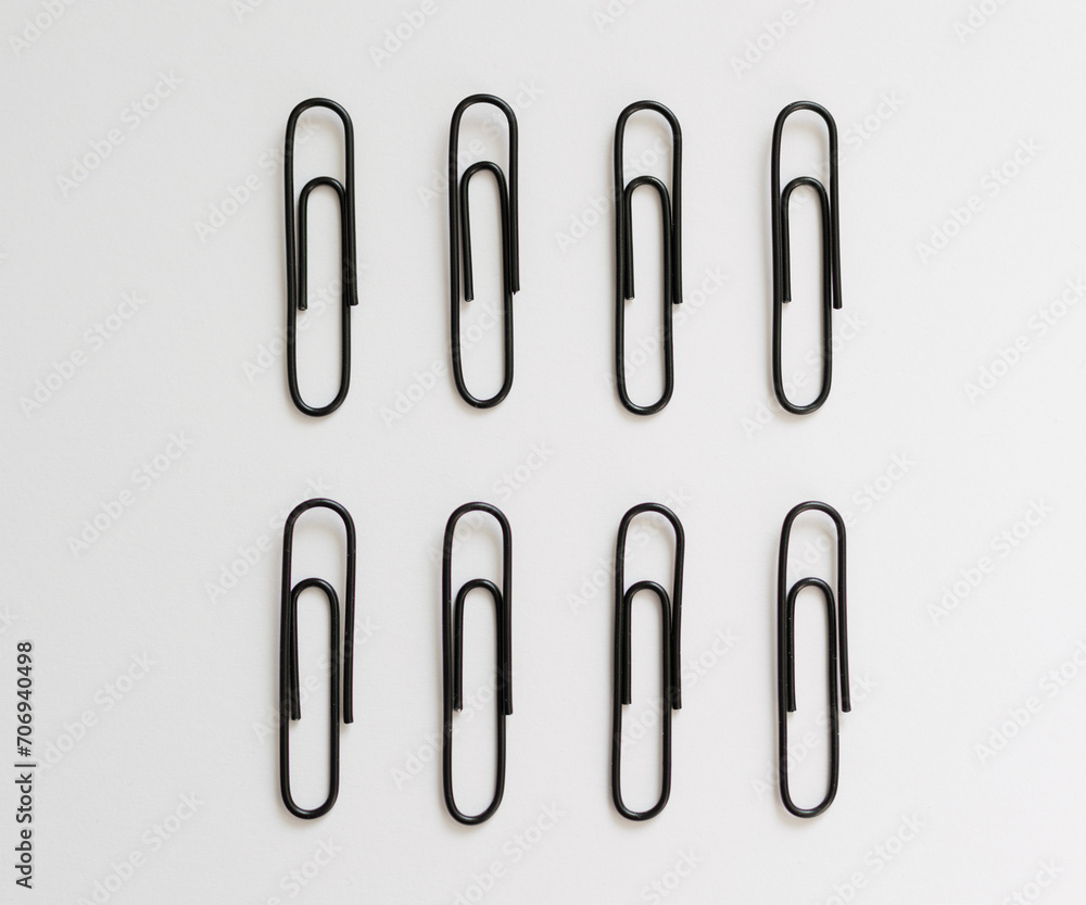 black paperclips on a white background black paperclips on a white background