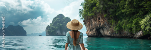 Rear view of woman wearing a straw hat on a boat in the sea outside a beautiful island resort © เลิศลักษณ์ ทิพชัย
