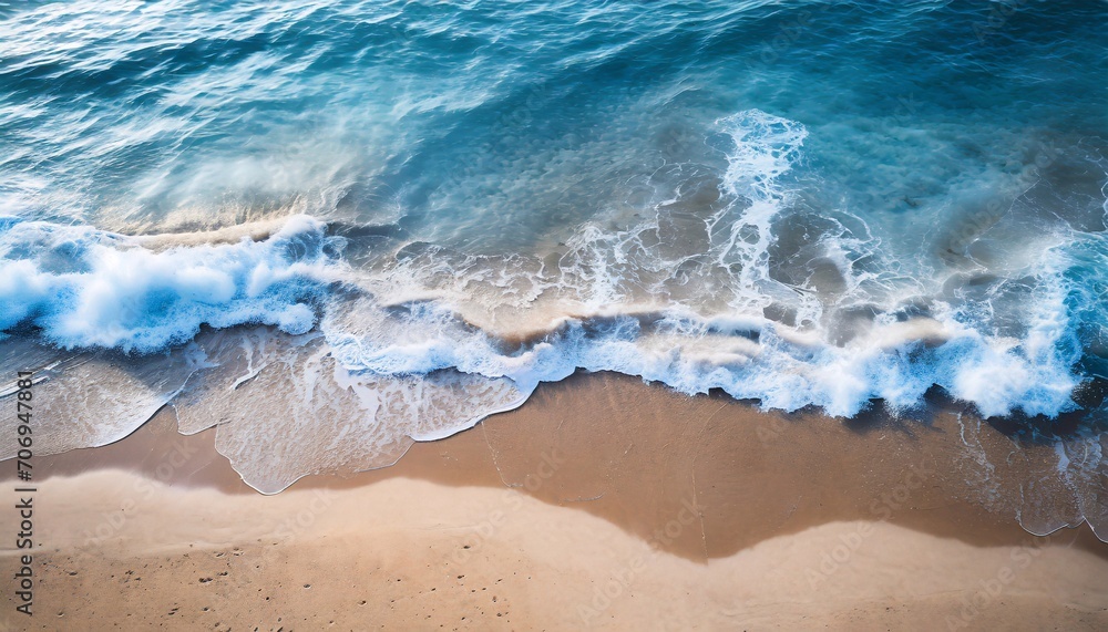 Ocean waves on a sandy beach. Blue water background. Recreation concept.
