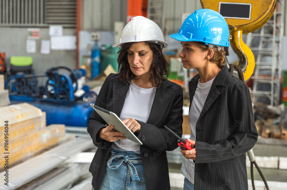 Two expert engineer woman working together in manufactory factory Two expert engineer woman working together in manufactory factory