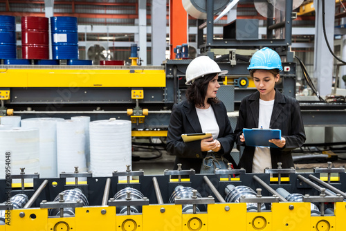Female engineers working on production lines in industrial inventory manufacturing factory