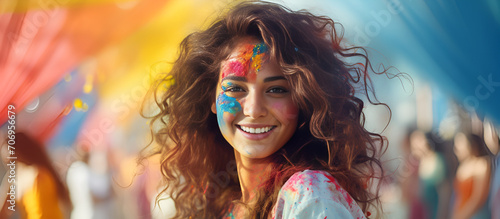 Portrait of a young woman at the Holi festival, expressing joy. Cheerful Holi Moments: Woman Enjoying the Festival